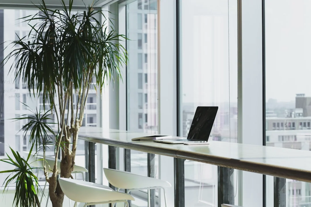 A clean and organized home office desk with a cleaner bottle and sponge, emphasizing simplicity and functionality.
